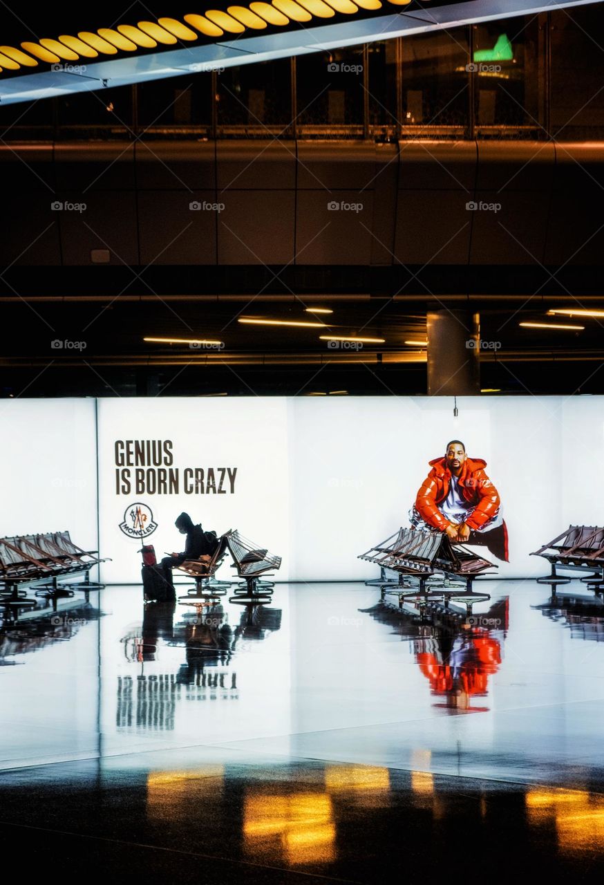 Silhouette of tourist sit in front of beautiful billboards at air port