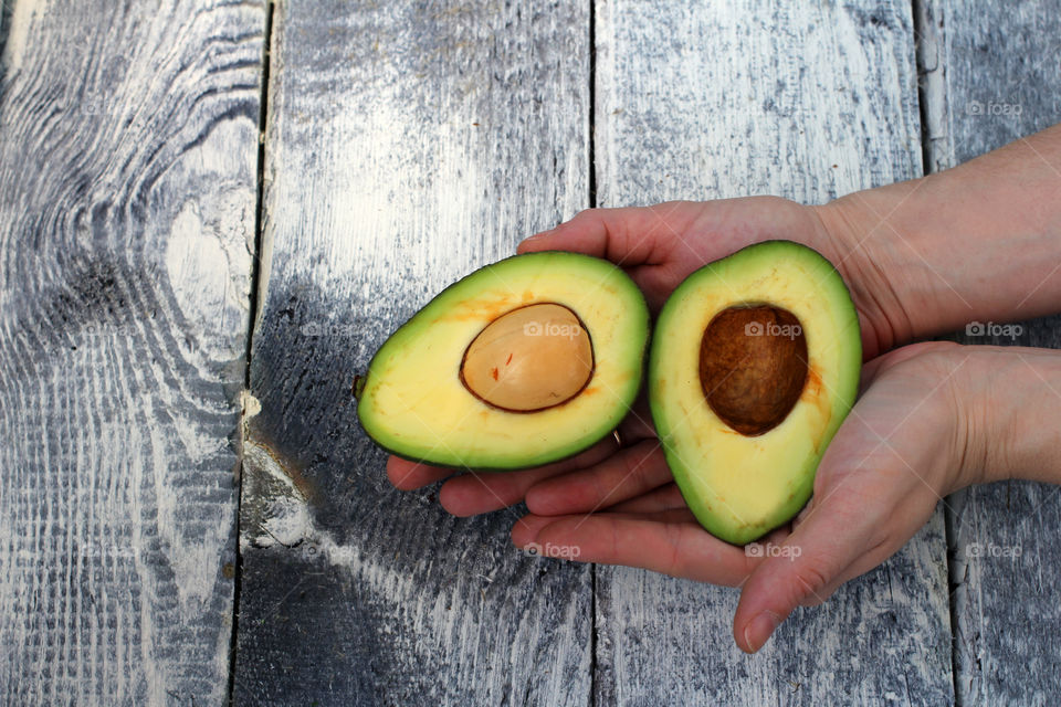 Hands, female hands, avocado in hands, avocado, fruit, food, abstraction, still life