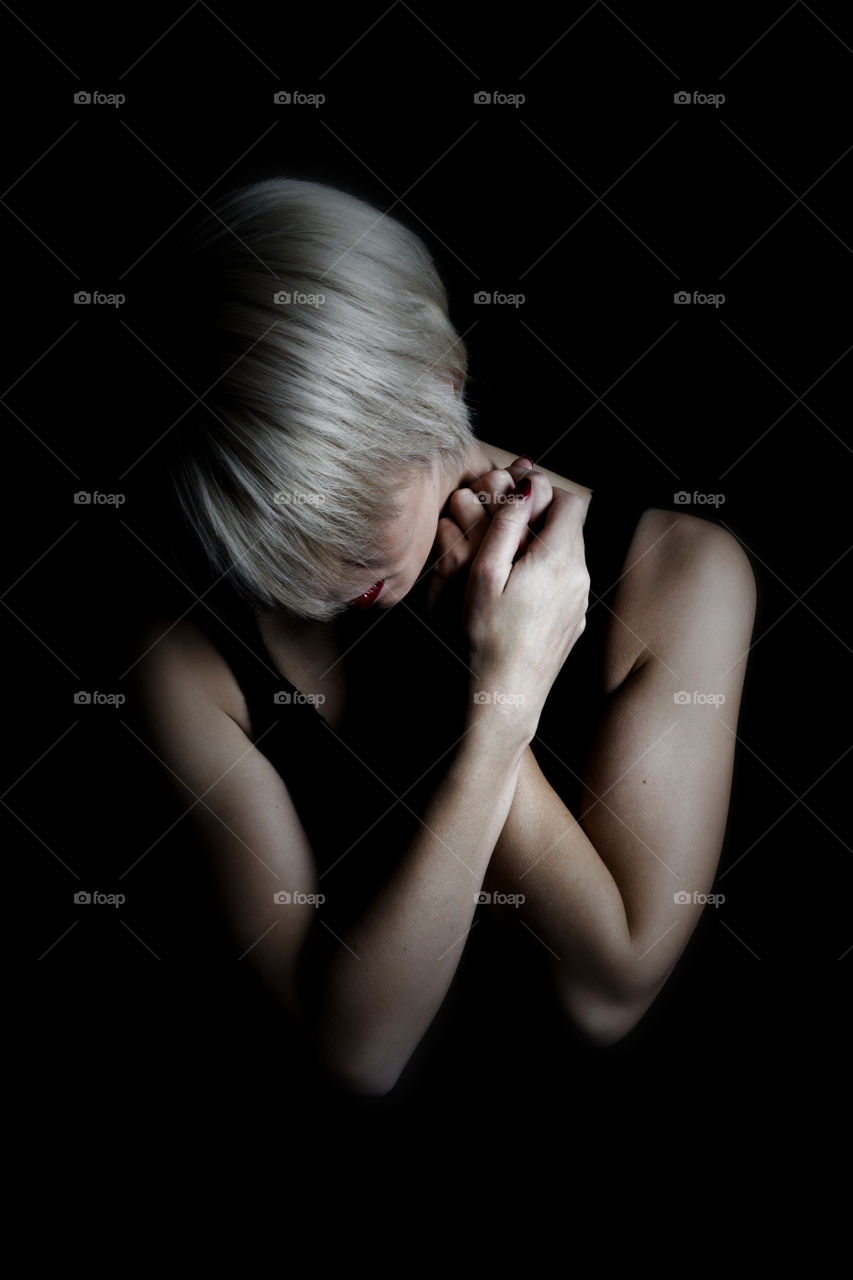 Close-up of a woman on black background
