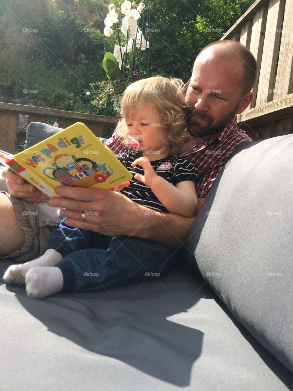 Father and daughter reading book