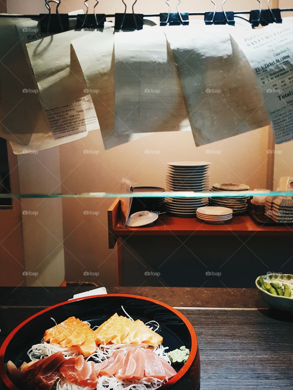 At the counter of the sushi bar