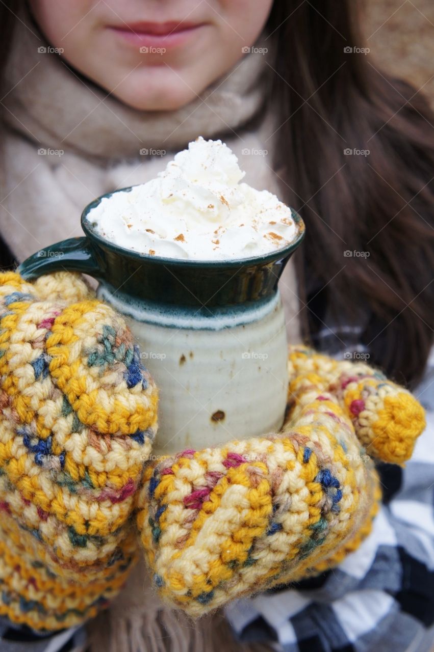 Women holding mug with cream
