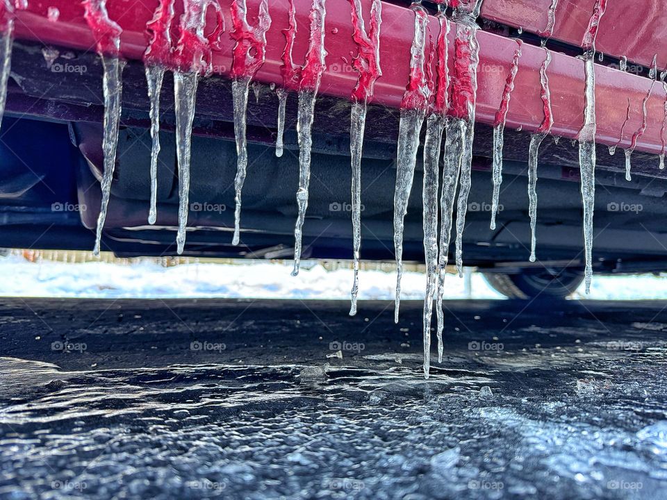 Icicles on a red car 