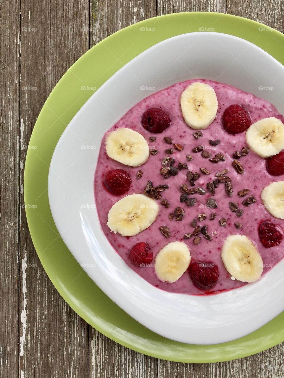 Smoothie in bowl on wooden table