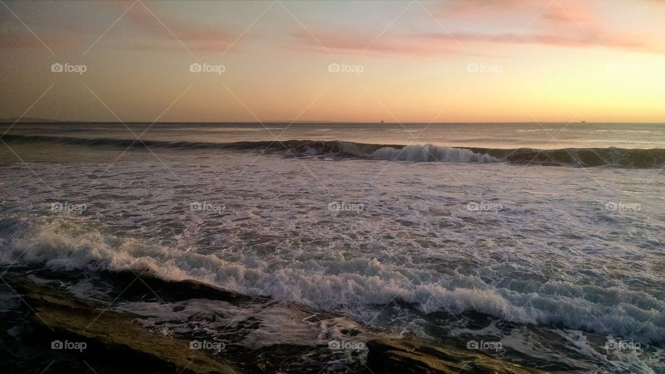 waves breaking at sunset