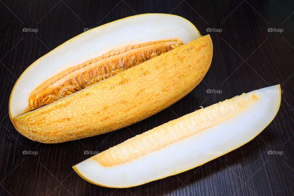 appetizing melon yellow on a brown wooden table