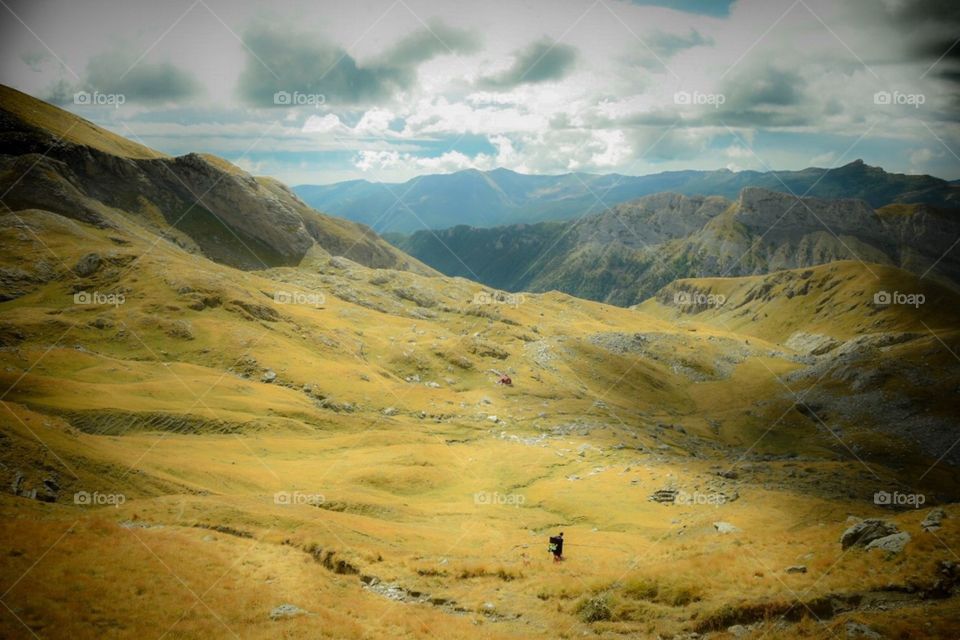 landscape with hiker in the italian alps.