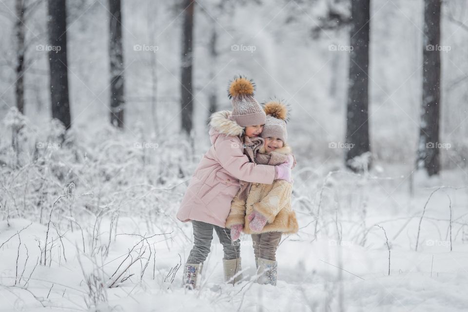 Little sisters in a winter park