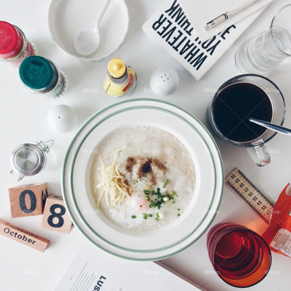 Morning Rituals : Breakfast with Pork Porridge and coffee on messy desk