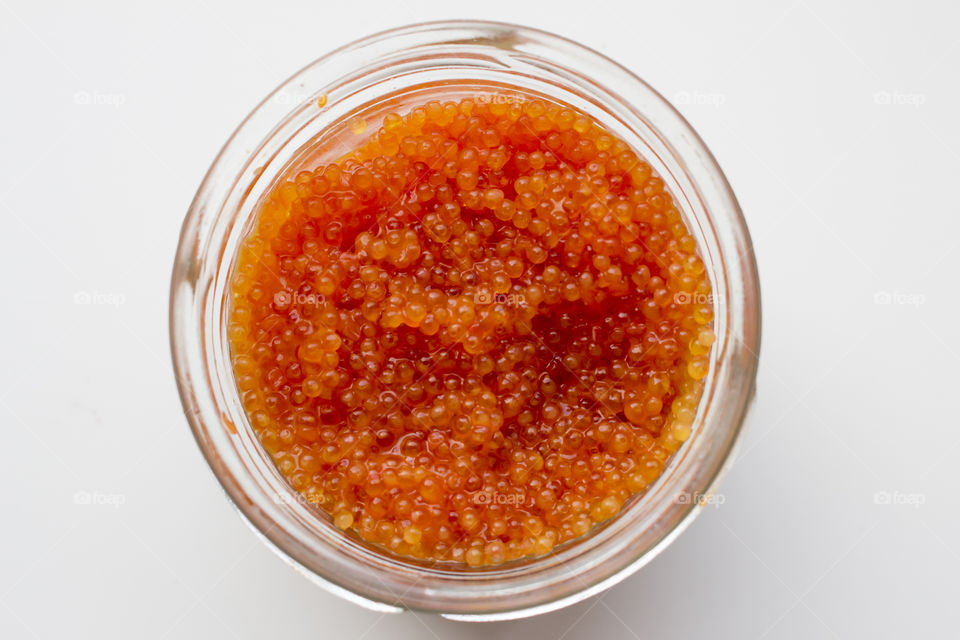Orange caviar in a glass jar 