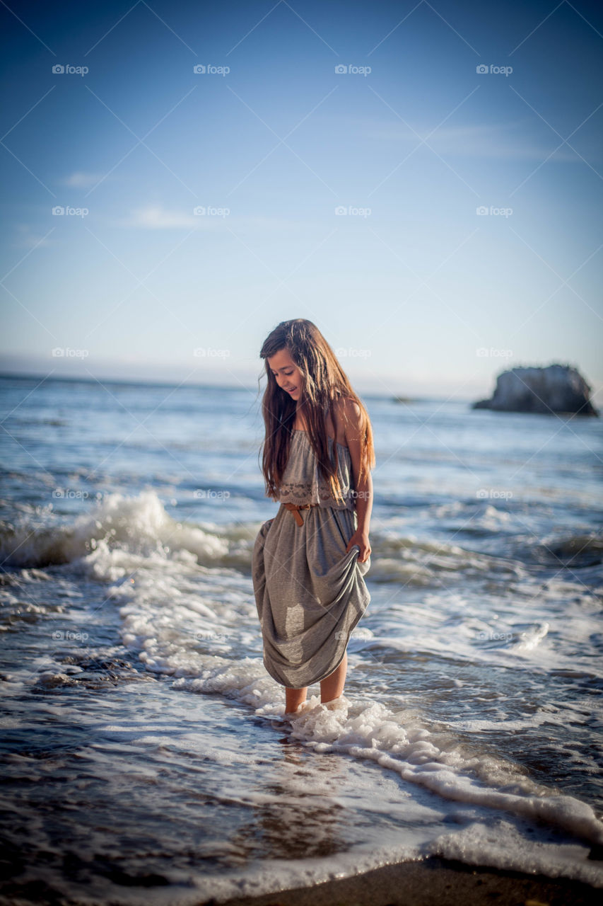 Summer days. Girl in the water at the beach 