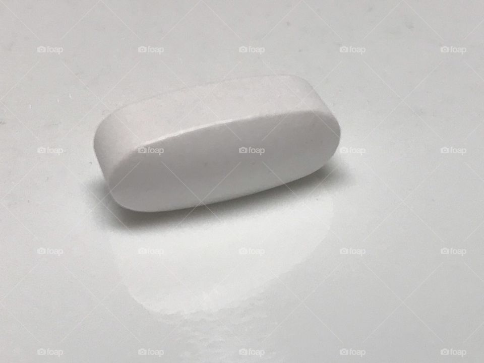 White pill on a white background 
