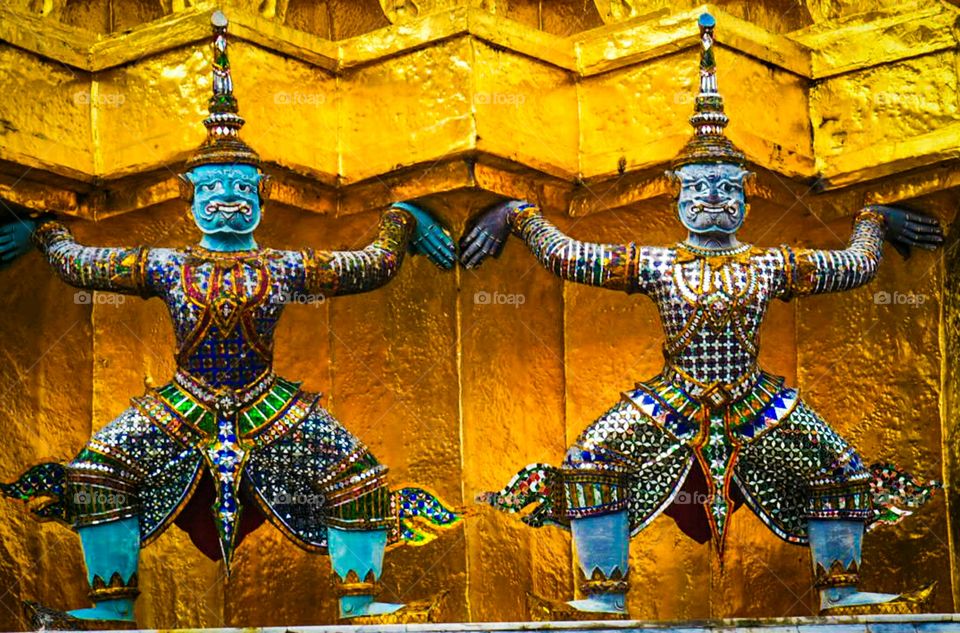 A giant statue at the base of The Temple of the Emerald Buddha in Bangkok.