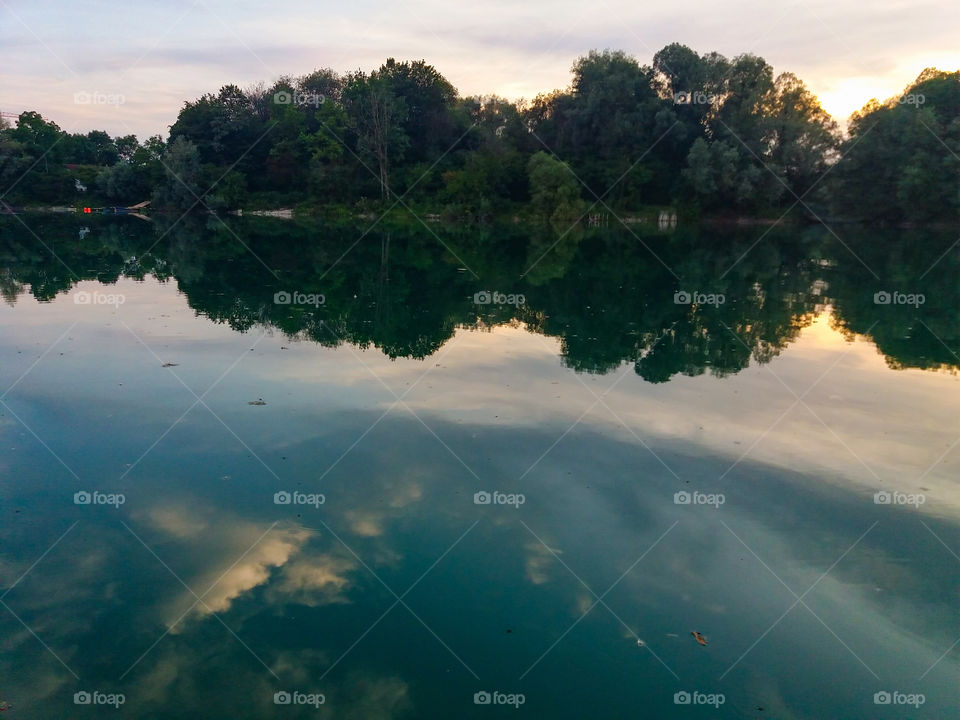 clouds reflecting on aquamarine waters summer sunset