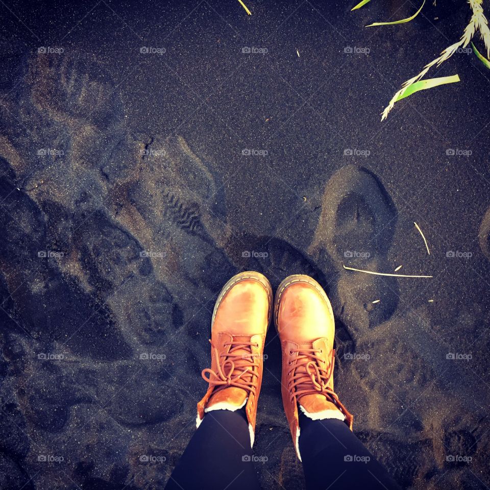 Dr martens standing on an Icelandic black sanded beach 