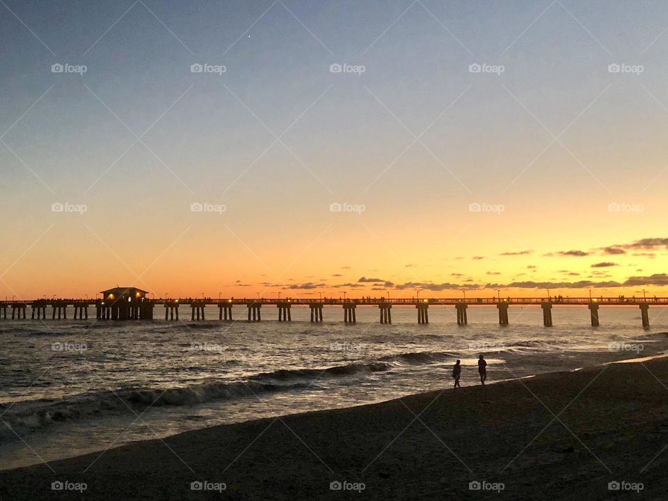 Sunset in autumn over here the Gulf of Mexico. The pier at Gulf Shores State Park, Alabama, United States.