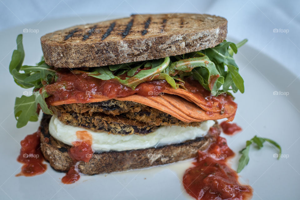 Eggplant Parmesan sandwich with fresh mozzarella, pepperoni and arugula