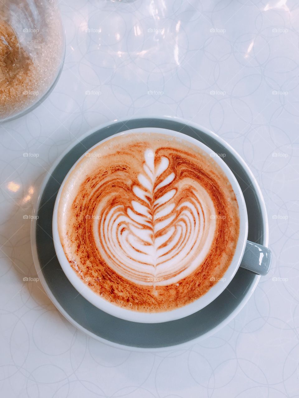 Cappuccino in grey cup and saucer