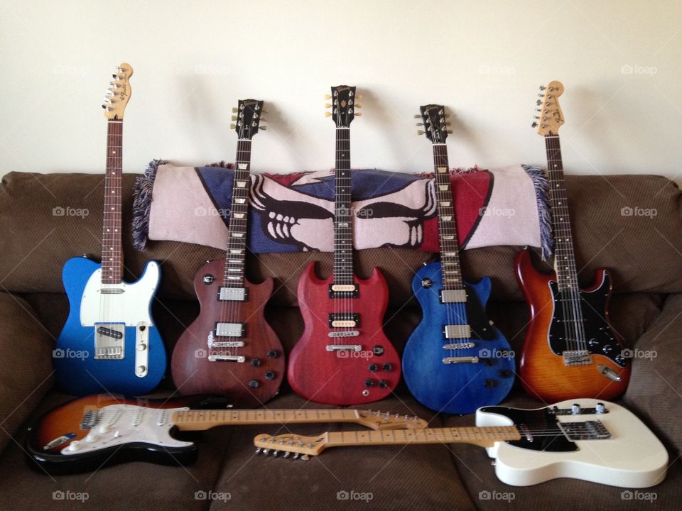 Fender/Gibson family. My fiancé's guitars looking pretty on the couch