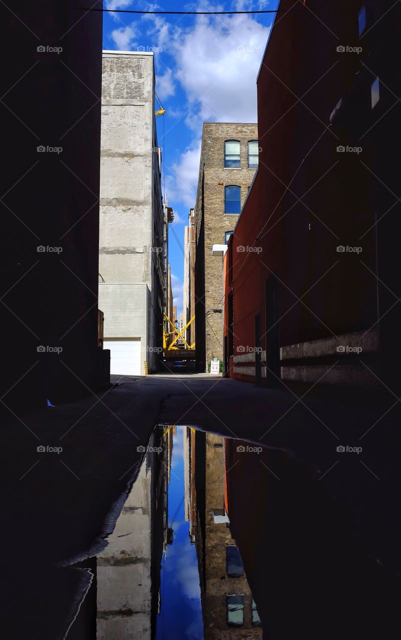 Reflection of buildings in puddle