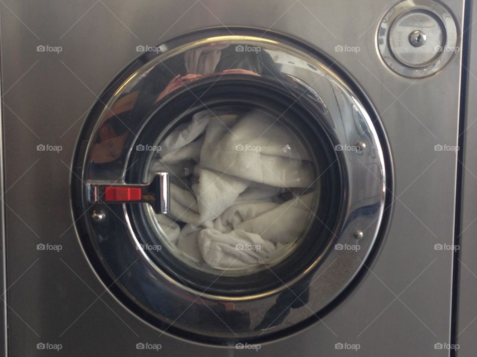 Washing machine full in launderette laundry 