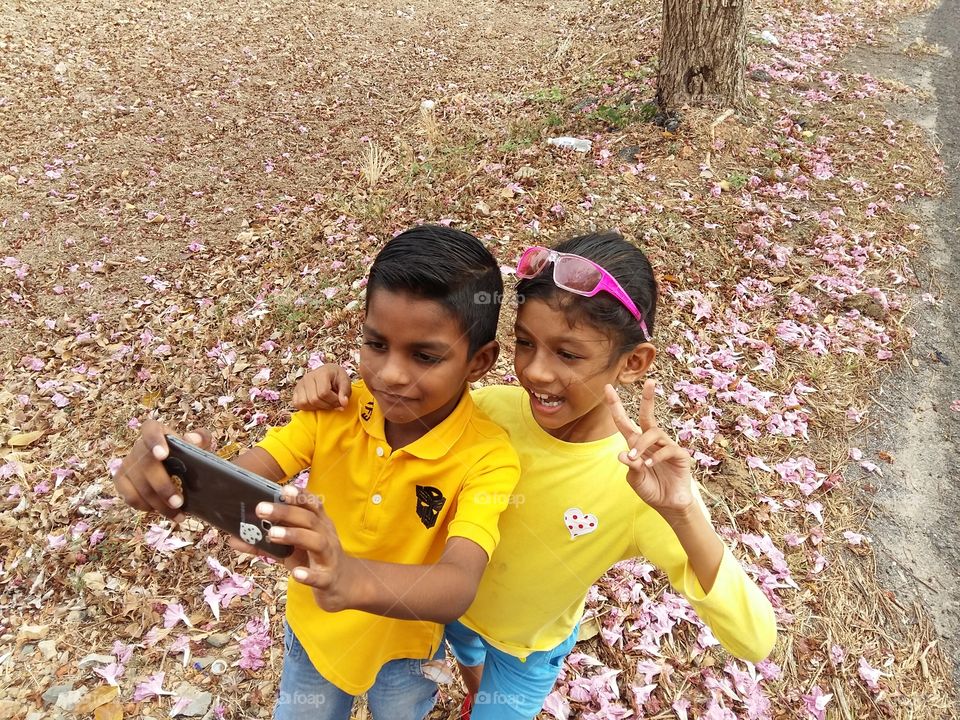 High angle view of two children's taking selfie