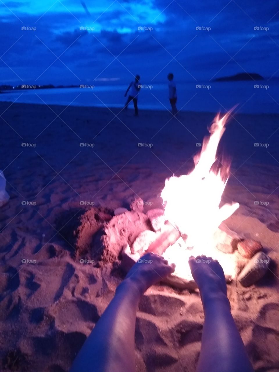 Flames keeping  feet warm on north Scotland beach my
