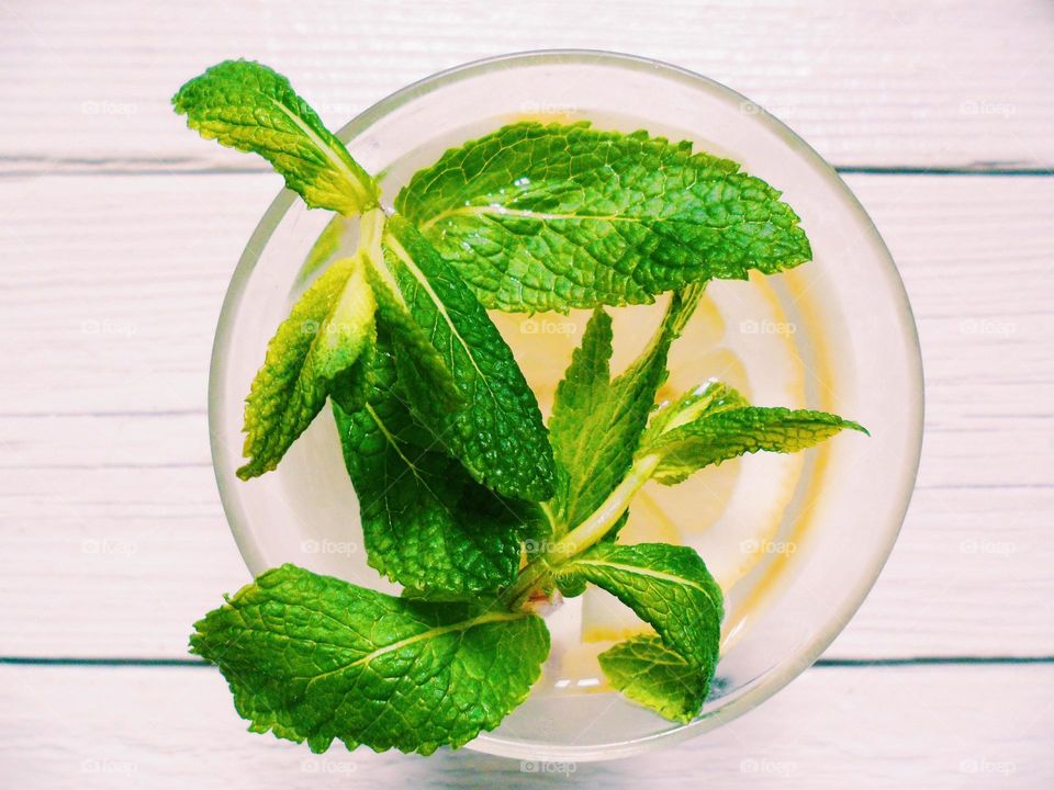 Homemade lemonade with lemon and mint leaves