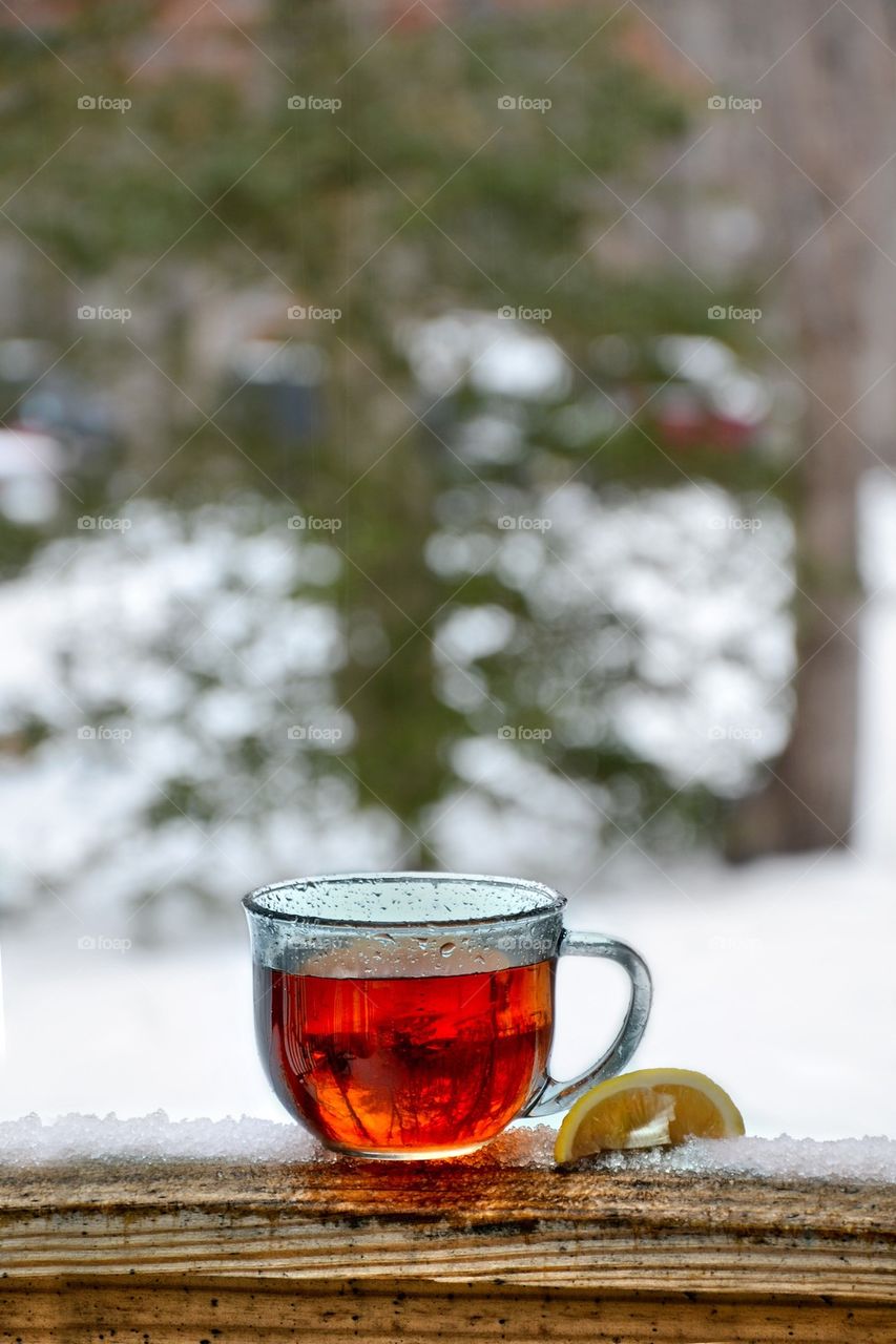 Hot tea and lemon on a snowy day 