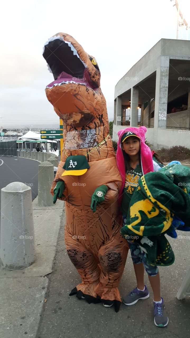 Customer dressing up as T-Rex.  not just this person but others too for dinosaur night at the ballpark.