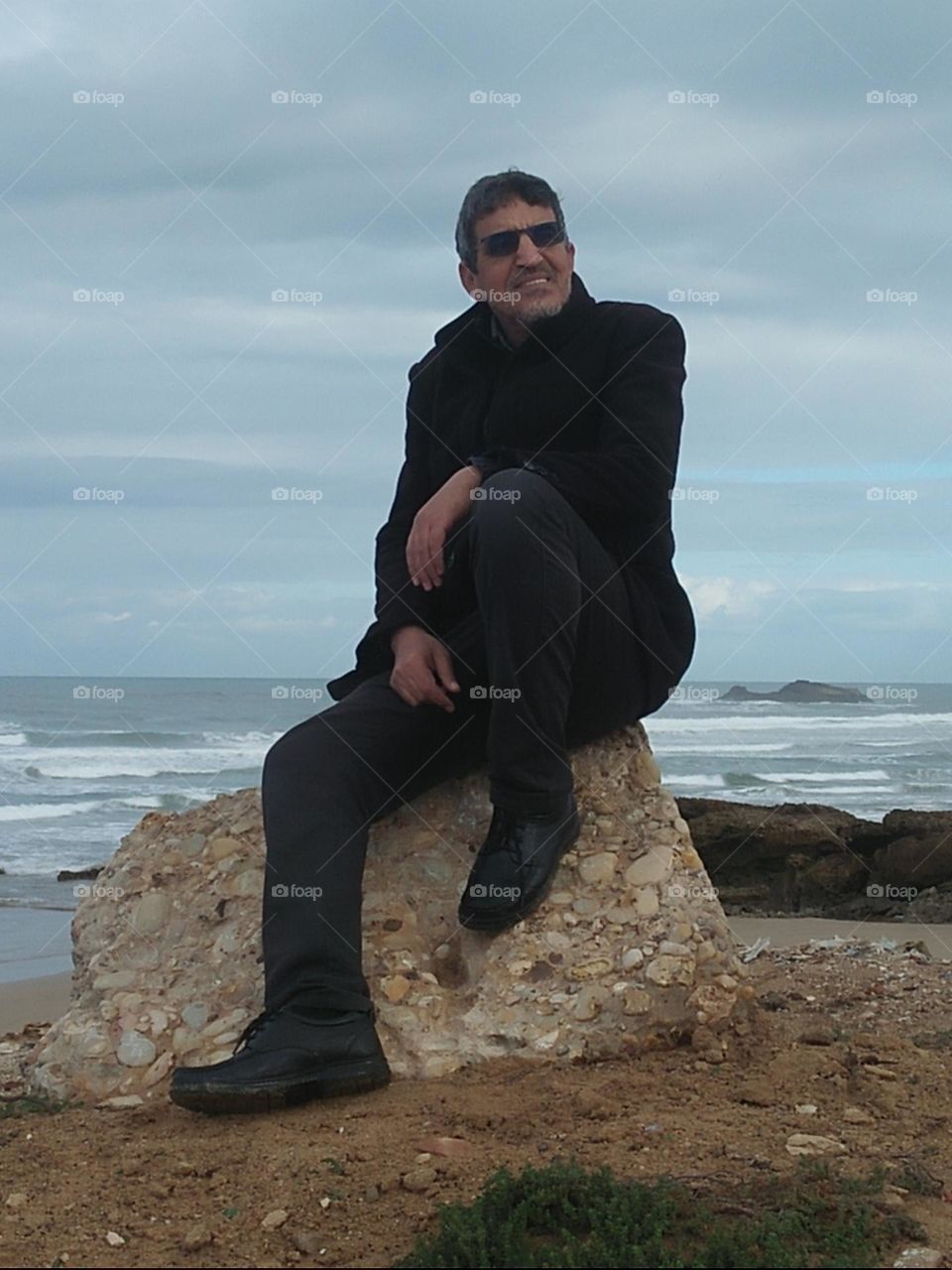 Im sitting on a rock near the beach at essaouira city in Morocco..