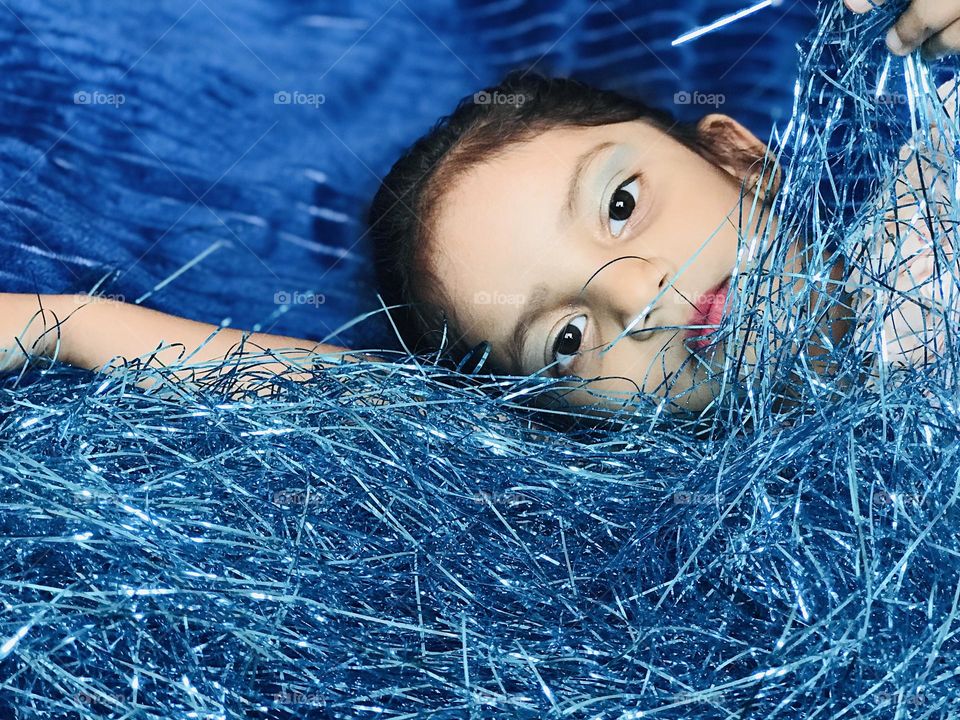 A girl in between every thing blue it looks very colourful 