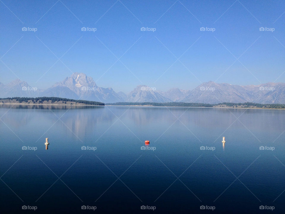 Grand teton reflects in the lake