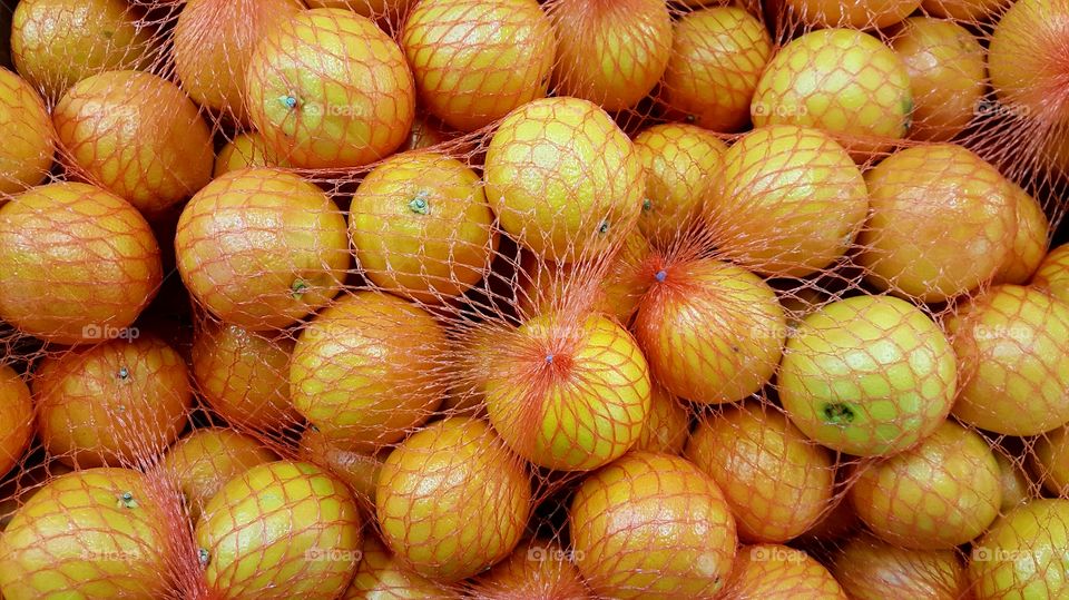 Close-up of orange fruit in net
