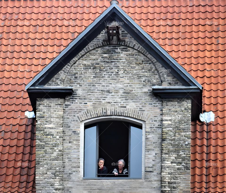 Two persons on their top window