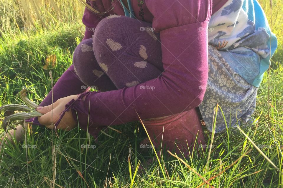 Girl playing with grass