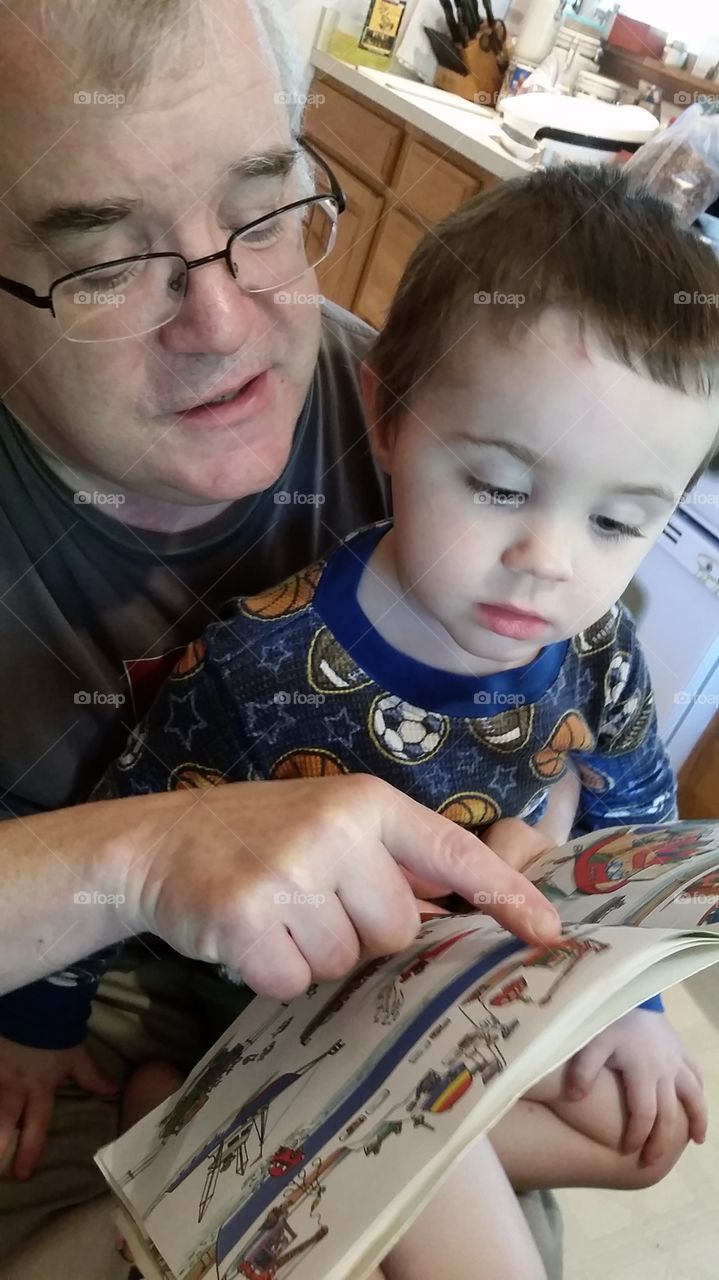 papa and bro reading. favorite activity