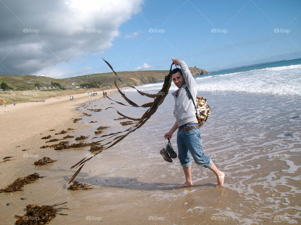 Spining around a long sea weed on the beach