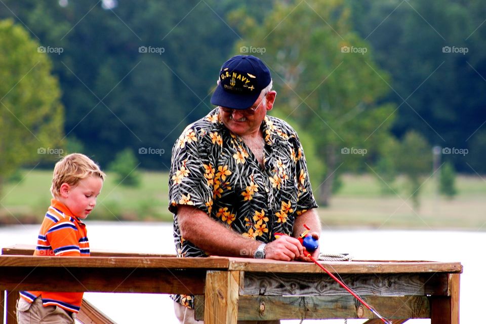 Grandfather fishing with grandson 