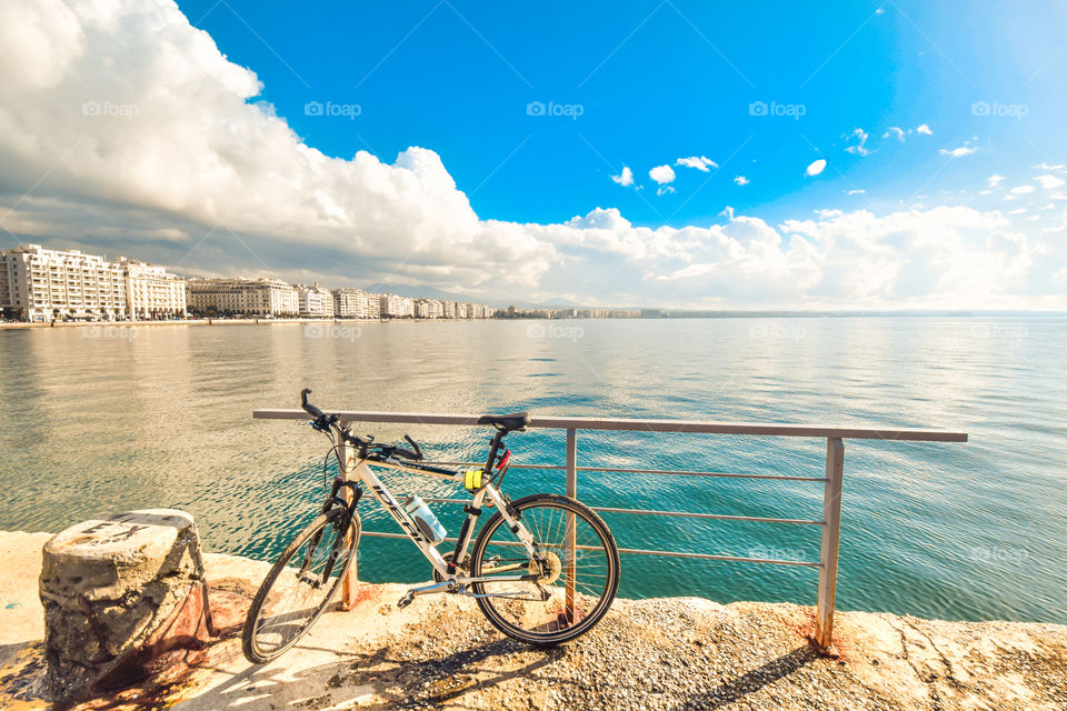 Cityscape In Overcast And A Parked Bicycle On The Seafront
