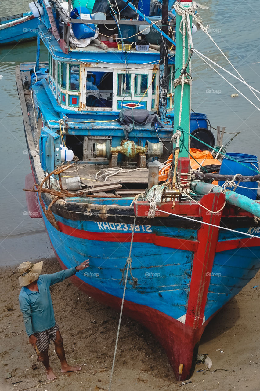 Fisherman with his colorful boat in Nha Trang, Vietnam 