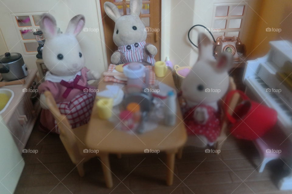 little bunny family sitting down to a meal in their cozy home