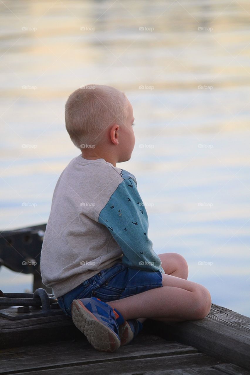 Boy looks out over the water