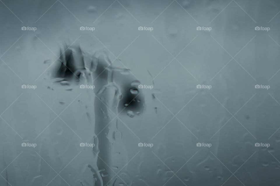 Minimal abstract scene parking lot lights through rainy window