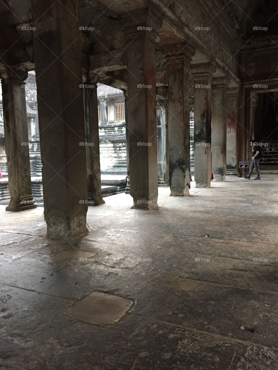 Columns in the ancient Cambodia temple, Angkor Wat. Shows old stone architecture in Asia. 