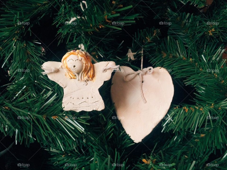 Little angel and heart decoration on christmas tree