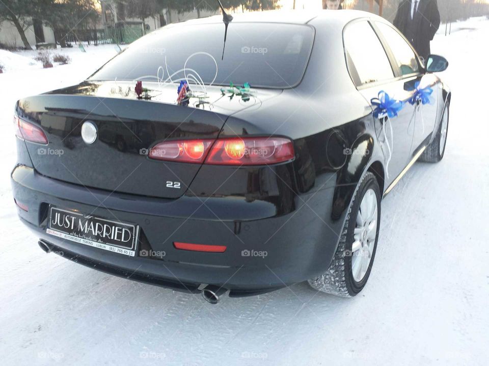 Our beloved Alfa Romeo car dressed in flowers for wedding ride