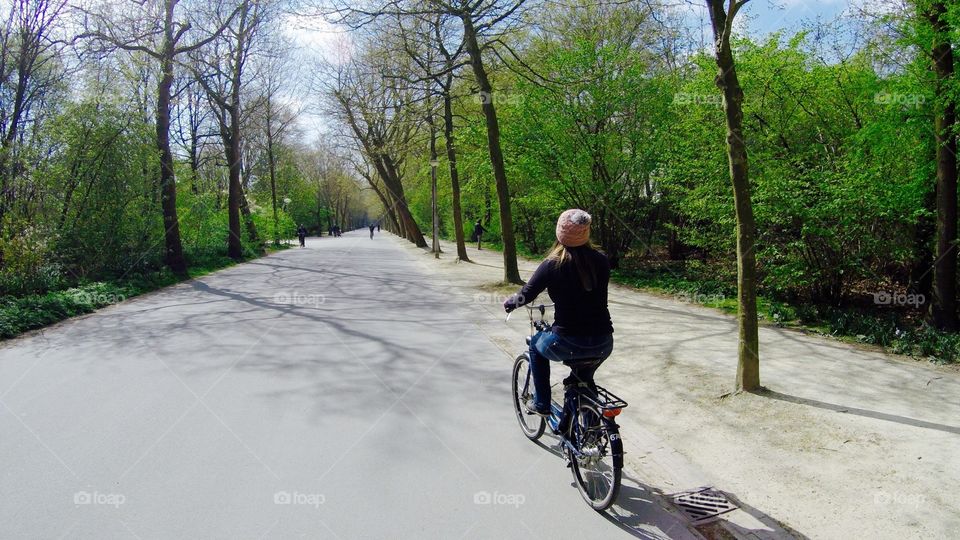 Bike and park. Girl Cycling at Amsterdam Park