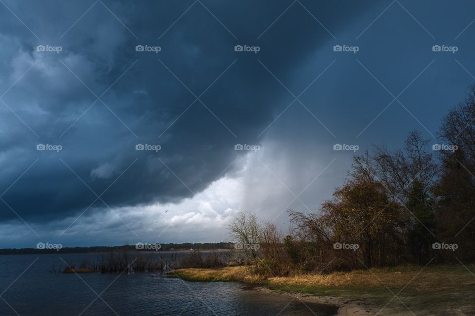 Storm clouds and rain over lake