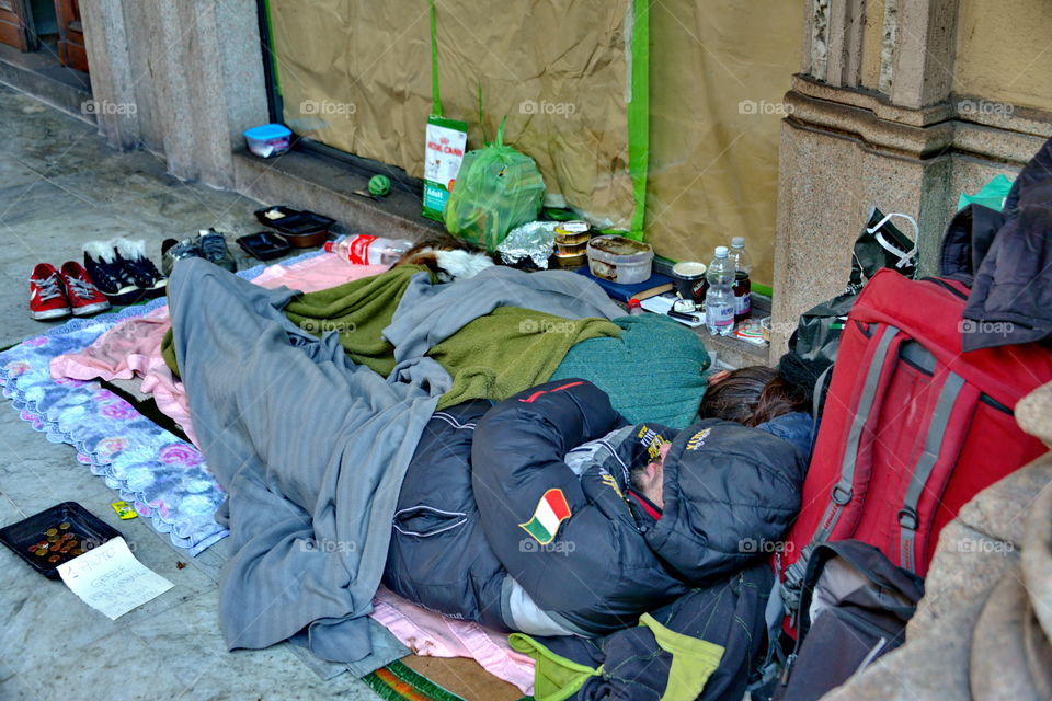homeless people sleeping on the sidewalk